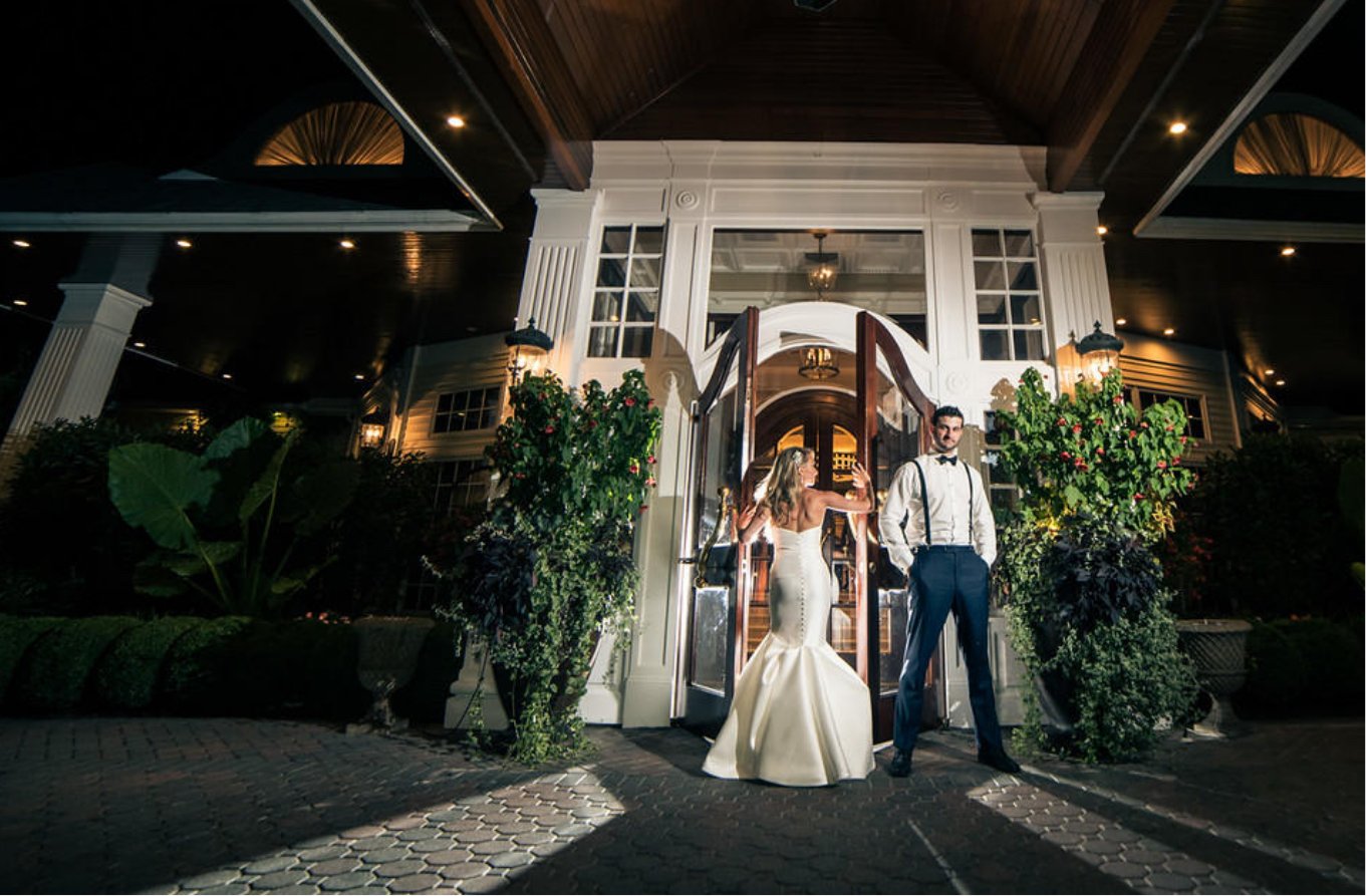 couple in front of watermill doors