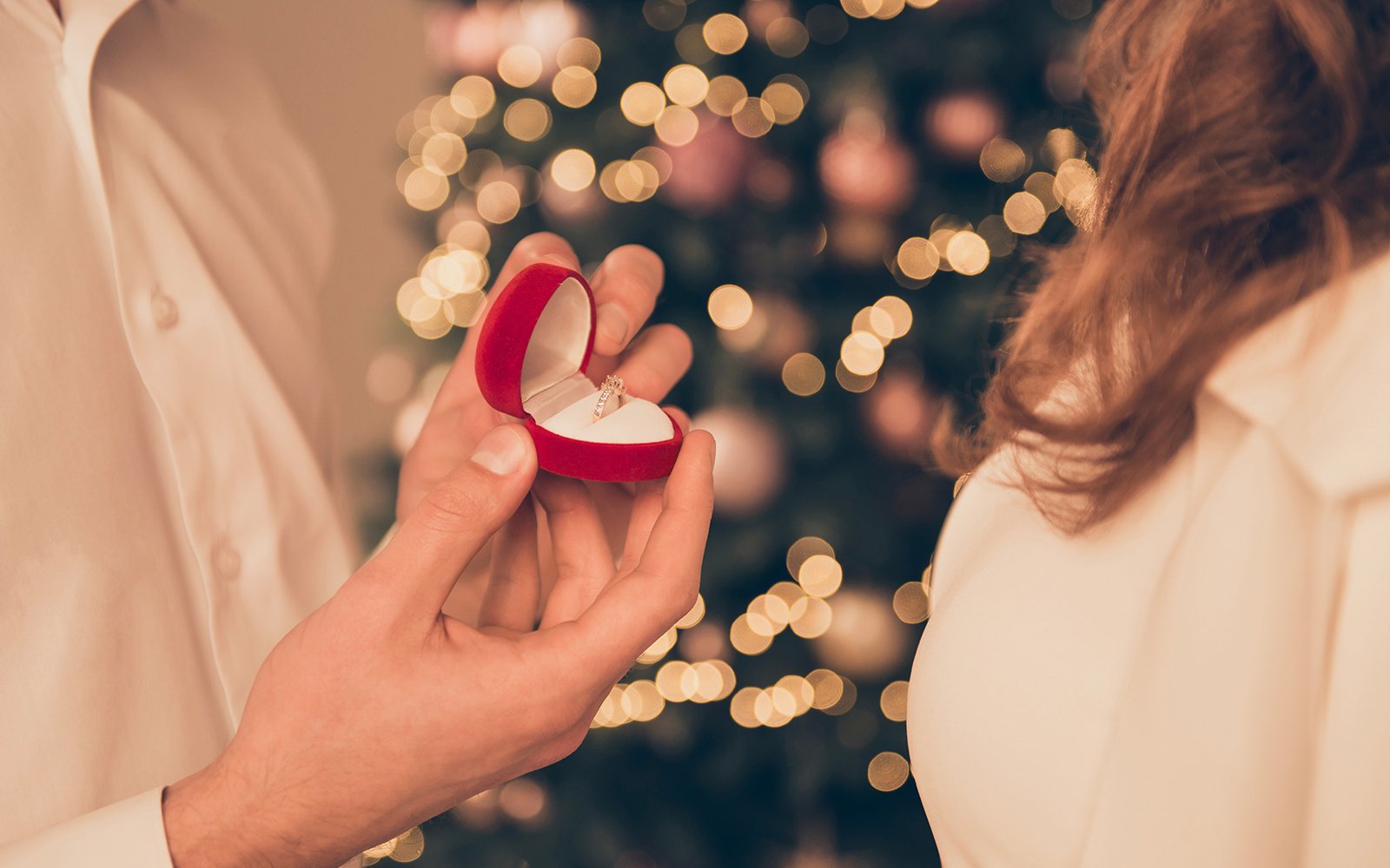 man proposing to woman with engagement ring