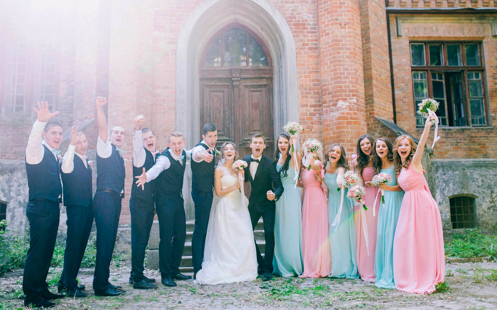 Bridesmaids and Groomsmen posing for fun photo at wedding with bride and groom